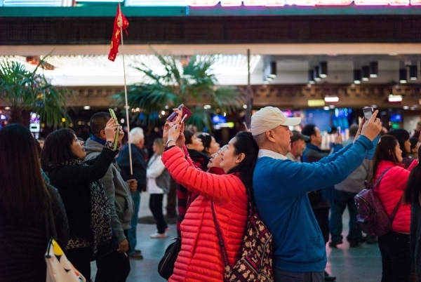 People take photos on the Fremont Street Experience in downtown Las Vegas on Tuesday, Nov. 17, 2015. Tuesday was the first day of the city‘s new ordinance requiring street performances to st ...