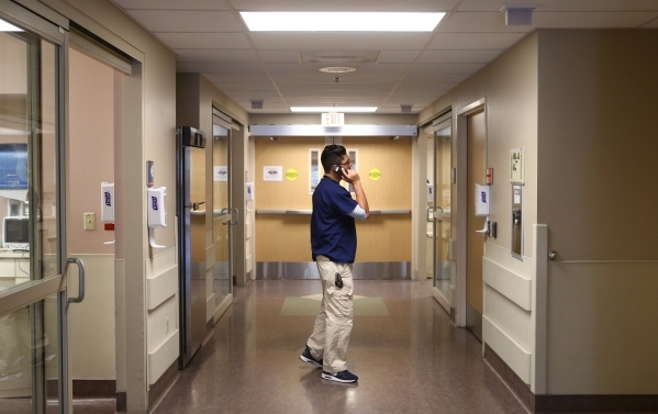 ER physician Christopher Nevarez takes a phone call in the emergency room at Southern Hills Medical Center in Las Vegas on Tuesday, Nov. 17, 2015. Chase Stevens/Las Vegas Review-Journal Follow @cs ...