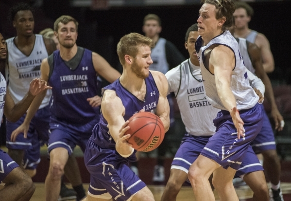 Stephen F. Austin basketball player Thomas Walkup, center with the ball, is defended by teammate Connor Brooks during practice as they prepare for their matchup against Prairie View A&M on Tha ...