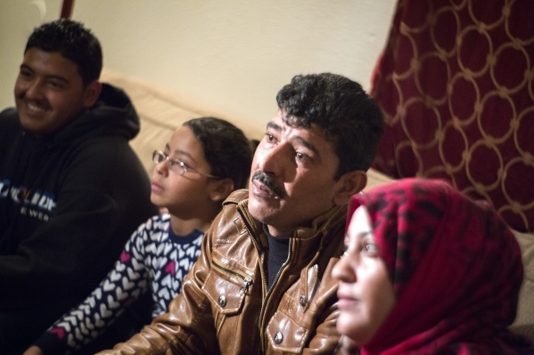 Syrian refugee family Khalid,  center,  father,  declined to give last name for security concerns, and is wife Safera, red scarf, with their children Adul Karim, 18, left, Retaj, 6, sit for an int ...