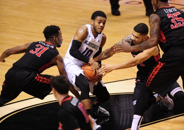 Creighton point guard Mo Watson Jr. (10) protects the ball from Rutgers guards Bishop Daniels, right, and Omari Grier (32) in the first half of their NCAA Basketball game at the MGM Grand Garden A ...