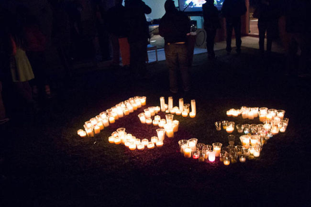 Candles are lit in the shape of the number 153, an estimate of people killed in the terror attacks in Paris. Secular groups organized the vigil at The Slammer in Las Vegas. (Ricardo Torres/Las Veg ...