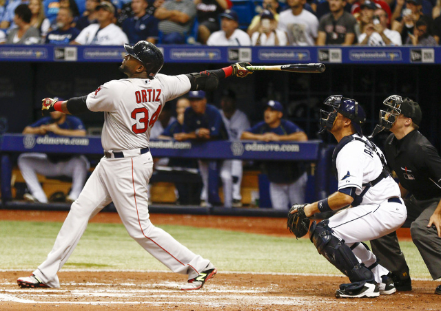 Sep 12, 2015; St. Petersburg, FL, USA; Boston Red Sox designated hitter David Ortiz (34) hits a fly ball to center for an out in his second at bat as Tampa Bay Rays catcher J.P. Arencibia (40) and ...