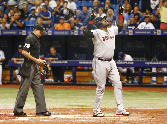 Sep 12, 2015; St. Petersburg, FL, USA; Boston Red Sox designated hitter David Ortiz (34) celebrates as umpire Adam Hamari looks on after Ortiz hits his 500th home run during the fifth inning of a  ...