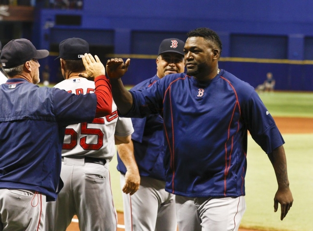 Sep 12, 2015; St. Petersburg, FL, USA; Boston Red Sox designated hitter David Ortiz (34) congratulates his teammates following a baseball game against the Tampa Bay Rays where he reached the 500 h ...