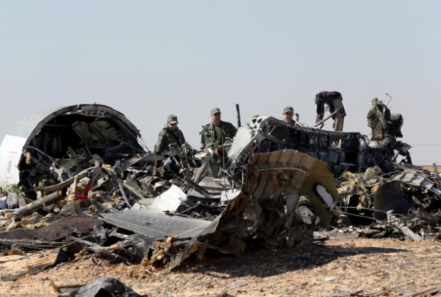 Military investigators from Egypt and Russia stand near the debris of a Russian airliner at the site of its crash at the Hassana area in Arish city, north Egypt, Nov. 1, 2015. (Mohamed Abd El Ghan ...