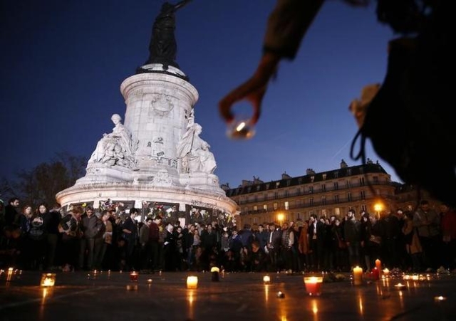 A candle is placed during a vigil in Place de la Republique following the series of deadly attacks in Paris, November 15, 2015. REUTERS/Benoit Tessier