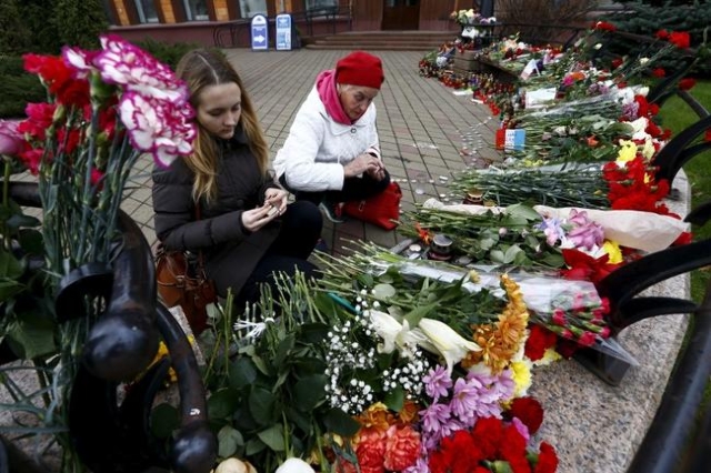 Women light candles to commemorate victims of the Paris attacks, in front of the French embassy in Minsk, Belarus November 16, 2015. (Reuters/Vasily Fedosenko)
