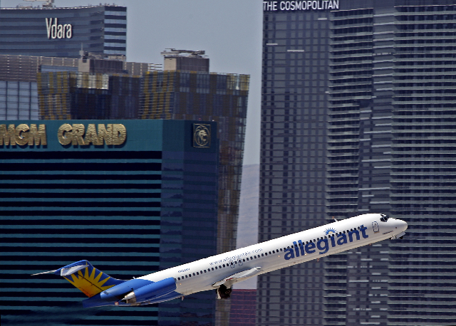 An Allegiant Air jetliner takes off from McCarran International Airport with a view of the Las Vegas Strip in the background. (John Gurzinski/Las Vegas Review-Journal)