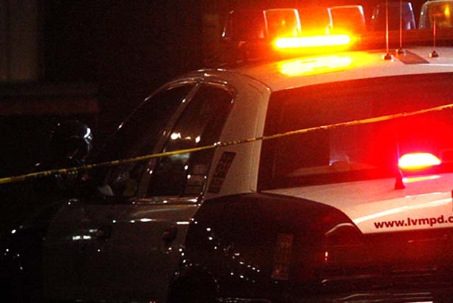 JESSICA EBELHAR/LAS VEGAS REVIEW-JOURNAL
Las Vegas police are seen at the scene of an officer-involved shooting at Travel Inn on Fremont Street in Las Vegas on Tuesday, Jan. 31, 2012.