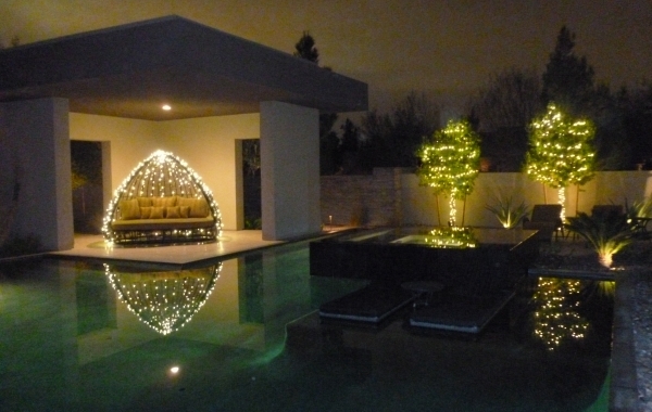 The pool area is a perfect place to string lights, which reflect off the water. COURTESY COURTNEY LIGHTS