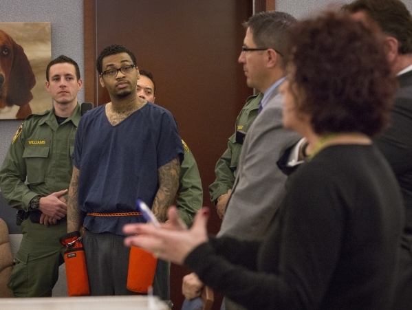 Self-proclaimed pimp and accused killer Ammar Harris listens while prosecutor Lisa Luzaich,right, speaks during sentencing in Clark County District Court on Wednesday, Feb. 26, 2014. District Judg ...