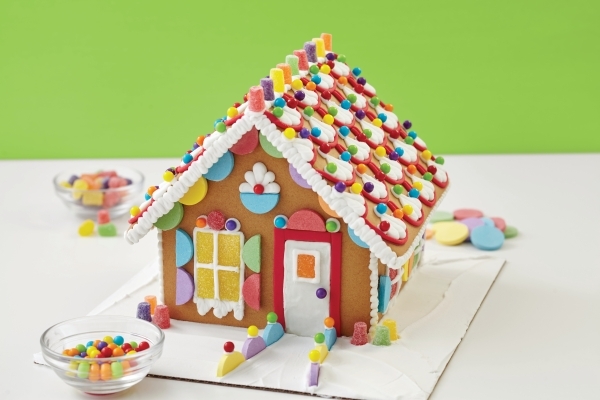 Instructors help kids and parents assemble a gingerbread house at Michaels. COURTESY MICHAELS