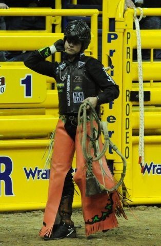 Bull rider Sage Kimzey from Strong City, Okla., reacts after being bucked from his bull during the first go-round of the 2015 Wrangler National Finals Rodeo at the Thomas & Mack Center in Las ...