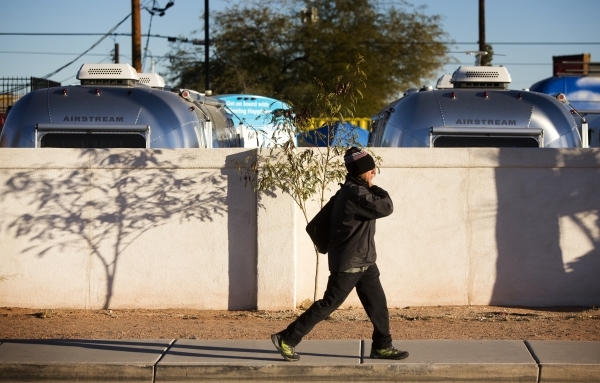 A man walks by a site holding Airstream camper trailers  on Fremont Street and 9th Street on Friday, Jan,2, 2015. Zappos CEO Tony HsiehÃ­s newest project in downtown Las Vegas is an urban campin ...