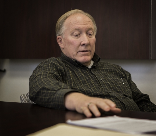 Boulder City Attorney Dave Olsen views a police file on former Boulder City Animal Control supervisor Mary Jo Frazier on Tuesday, Dec. 1, 2015. Frazier was under criminal investigation for illegal ...