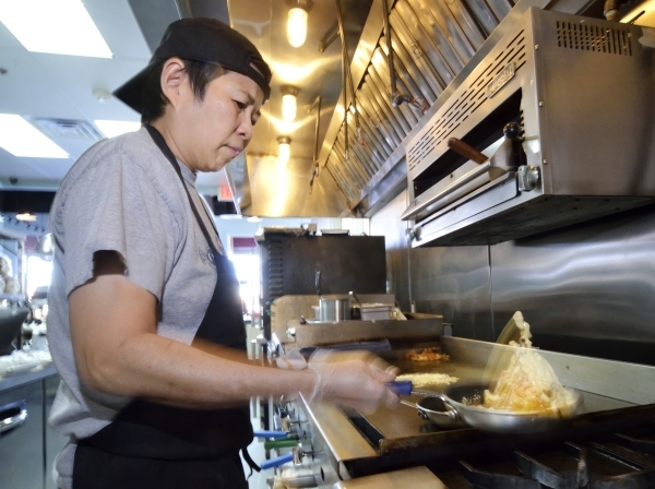 Chef Jackie Lim prepares a Breakfast Mac Ã¾ÃÃ´N Cheese at the Truffles N Bacon Cafe at 8872 S. Eastern Ave. in Las Vegas on Saturday, Dec. 5, 2015. The dish is made with bacon, hash browns, ...