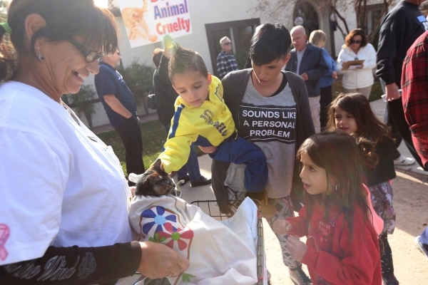 Ciska Roberts, third from left, lets her children pet Charlotte Tallas‘ cat Ziggie at a rally at the Boulder City Police Department to demand a case of animal cruelty against former Animal C ...