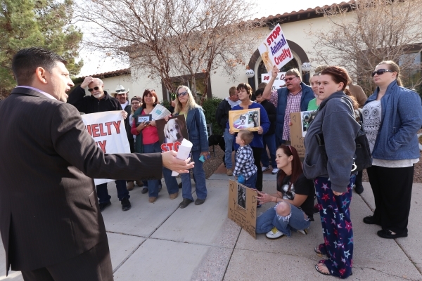 The crowd listens to State Sen. Mark Manendo at a rally at the Boulder City Police Department to demand a case of animal cruelty against former Animal Control Supervisor Mary Jo Frazier be sent to ...