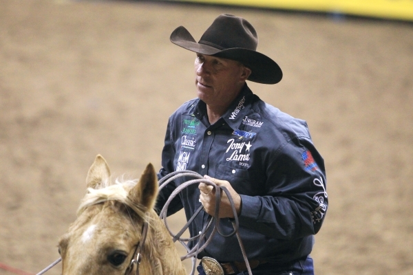 Jake Barnes from Scottsdale, Ariz. competes in the team roping competition during the first go around at the National Finals Rodeo Thursday, Dec. 4, 2014 at the Thomas & Mack Center. (Sam Morr ...