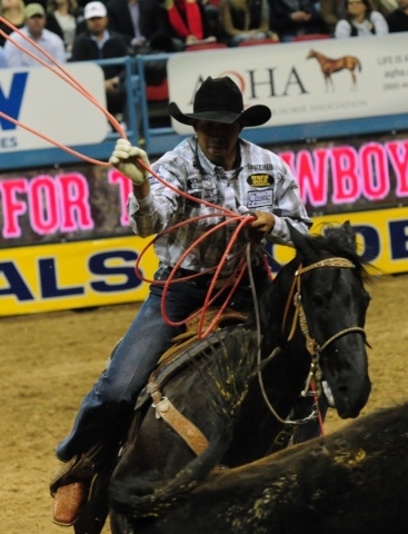 Team roper Junior Nogueira from Scottsdale, Ariz., lassos a calf during the first go-round of the 2015 Wrangler National Finals Rodeo at the Thomas & Mack Center in Las Vegas Thursday, Dec. 0 ...