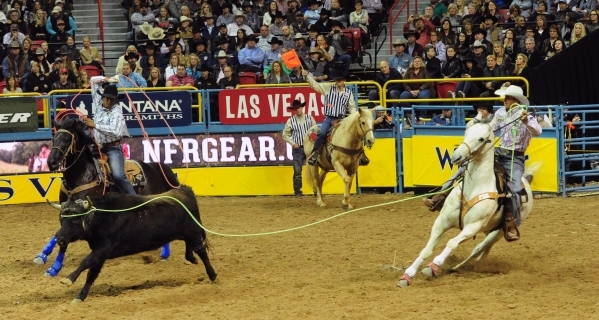 Team ropers Junior Nogueira from Scottsdale, Ariz., left, and JoJo LeMond from Andrews, Texas, are seen during the first go-round of the 2015 Wrangler National Finals Rodeo at the Thomas & Mac ...