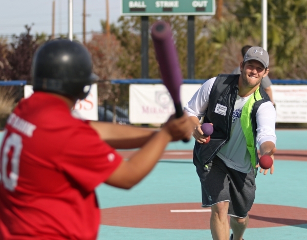 Los Angeles Dodgers‘ Clayton Kershaw, right, pitches the ball to Nino during a Miracle League of Las Vegas baseball game Saturday, Dec. 5, 2015, in Las Vegas. Kershaw, a 2014 National League ...