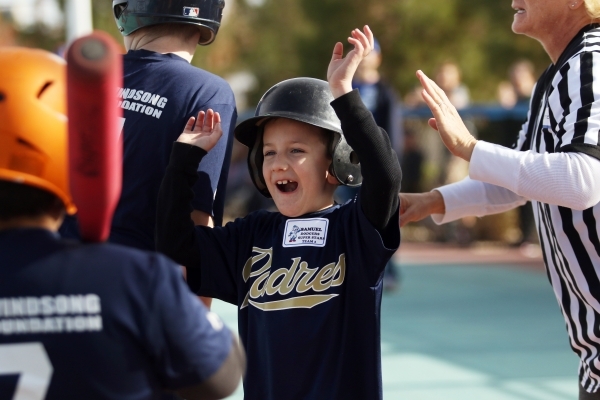 Samuel cheers as he arrives home during a Miracle League of Las Vegas baseball game Saturday, Dec. 5, 2015, in Las Vegas. Clayton Kershaw, a 2014 National League Most Valuable Player, was special  ...