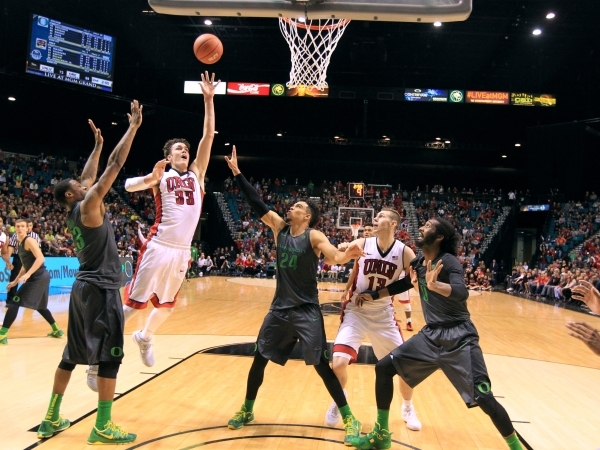 UNLV‘s Stephen Zimmerman Jr. puts up a shot between Oregon forward Elgin Cook, left, and Oregon forward Dillon Brooks on Dec. 4, 2015, at the MGM Grand Garden Arena. UNLV defeated No. 16 Ore ...