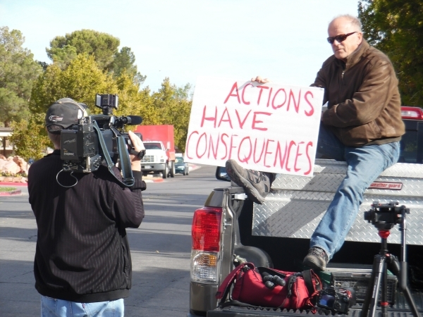 An unidentified man protests outside Boulder City Police Department on Dec. 3. He and dozens of others protested Police Chief Bill Conger‘s decision to not pursue charges against retired for ...