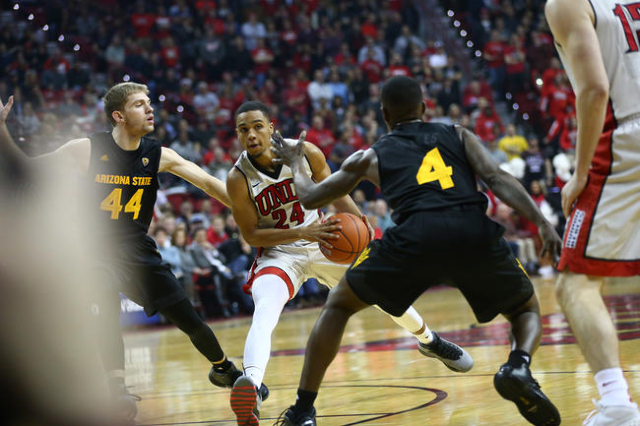 UNLV guard Jalen Poyser (24) drives against Arizona State guards Kodi Justice (44) and Gerry Blakes (4) during a basketball game at the Thomas & Mack Center in Las Vegas on Wednesday, Dec. 16, ...