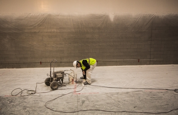 A worker wipes paint the warehouse area of the store, at 215 Beltway at Durango Drive, on Thursday, Dec. 17,2015. The 351,000 square foot home furnishing store is scheduled to open next summer. J ...