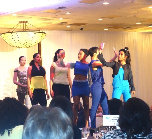 The fashion show audience was surprised to learn that the designer of these fashions, Kyler Baltimore, was just 11 years old, and she personally sewed each ensemble. The girls in front took selfie ...