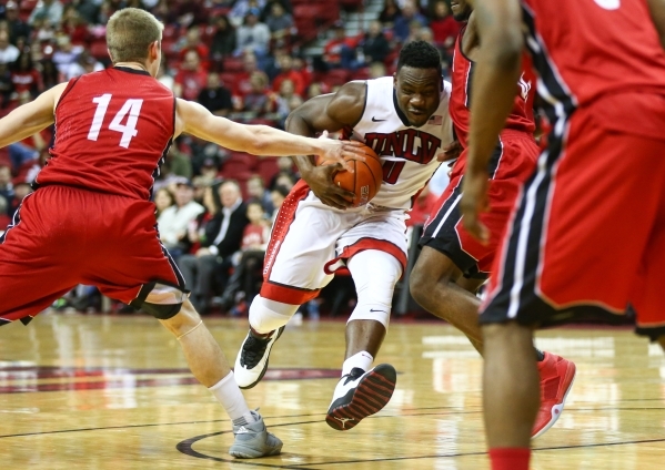 UNLV guard Ike Nwamu (0) drives past South Dakota‘s Casey Kasperbauer (14) during a basketball game at the Thomas & Mack Center in Las Vegas on Tuesday, Dec. 22, 2015. UNLV won 103-68. C ...