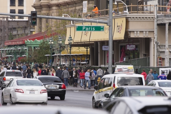 Pedestrians walk on the sidewalk in front of Paris Las Vegas in Las Vegas Monday, Dec. 21, 2015. Jason Ogulnik/Las Vegas Review-Journal.