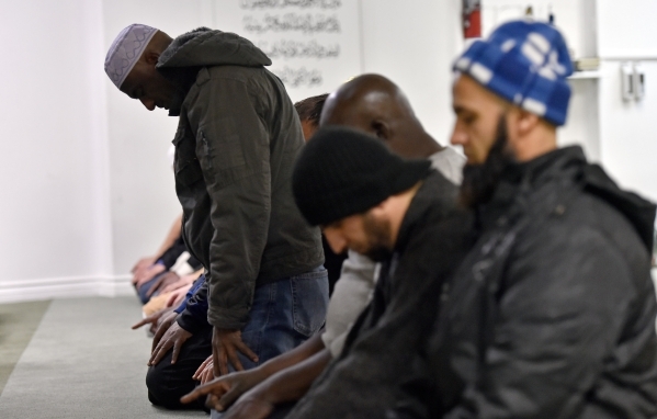 Said Ahmed, left, prays with a group of men at Masjid-e-Tawheed Tuesday, Dec. 29, 2015, in Las Vegas. A Muslim civil rights group is calling for a federal and state hate crime investigation after ...