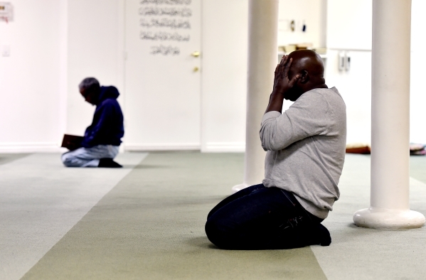Abdelkadr Seid, left and Muhyideen Umar pray at Masjid-e-Tawheed Tuesday, Dec. 29, 2015, in Las Vegas. A Muslim civil rights group is calling for a federal and state hate crime investigation after ...