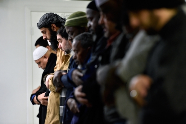 A group of men pray at Masjid-e-Tawheed Tuesday, Dec. 29, 2015, in Las Vegas. A Muslim civil rights group is calling for a federal and state hate crime investigation after the door handles of the  ...