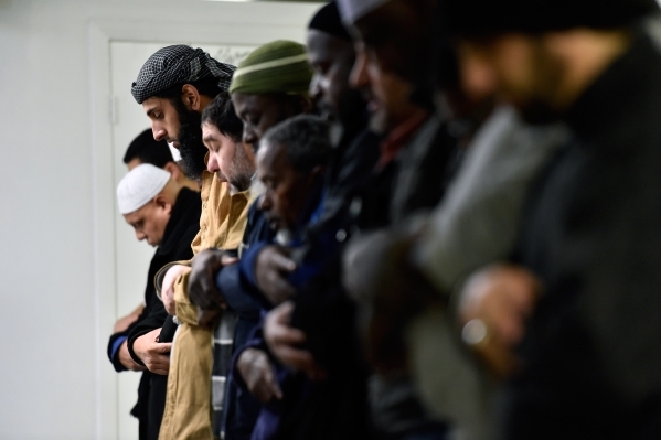 A group of men pray at Masjid-e-Tawheed Tuesday, Dec. 29, 2015, in Las Vegas. A Muslim civil rights group is calling for a federal and state hate crime investigation after the door handles of the ...