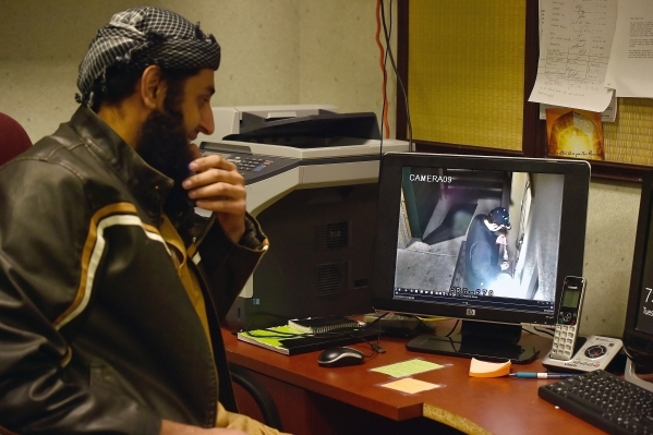 Board member Humeyoon Bhadelia at Masjid-e-Tawheed watches a video from a security camera at the mosque Tuesday, Dec. 29, 2015, in Las Vegas. A Muslim civil rights group is calling for a federal a ...