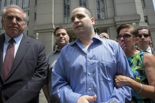 Former New York City police officer Gilberto Valle (C), dubbed by local media as the "Cannibal Cop," leaves the U.S. District Court for the Southern District of New York in Lower Manhatt ...