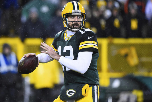 Nov 26, 2015; Green Bay, WI, USA; Green Bay Packers quarterback Aaron Rodgers (12) drops back to pass against the Chicago Bears during the second half for a NFL game on Thanksgiving at Lambeau Fie ...