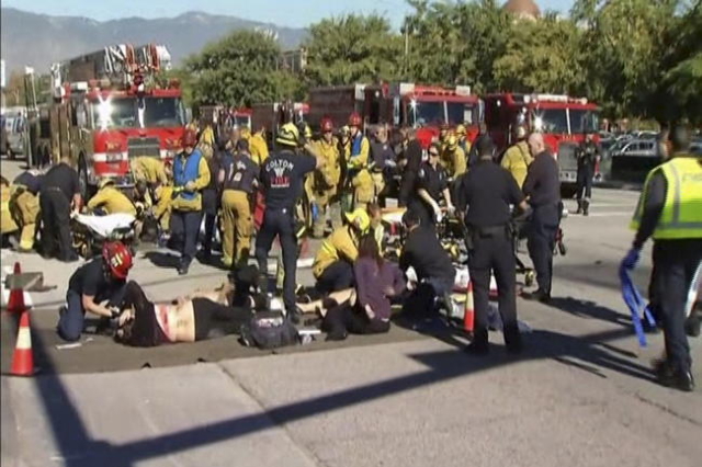 Rescue crews tend to the injured in the intersection outside the Inland Regional Center in San Bernardino, California in this still image taken from video December 2, 2015. REUTERS/NBCLA.com/Hando ...