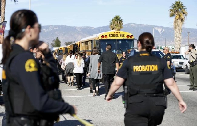Police officers transport bystanders from the area after at least one person opened fire at a social services agency in San Bernardino, California December 2, 2015. REUTERS/Mario Anzuoni