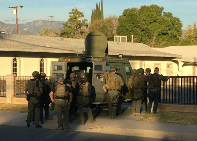 A police SWAT team searches a church during a manhunt after a mass shooting in San Bernardino, California December 2, 2015. Gunmen opened fire on a holiday party on Wednesday at a social services ...