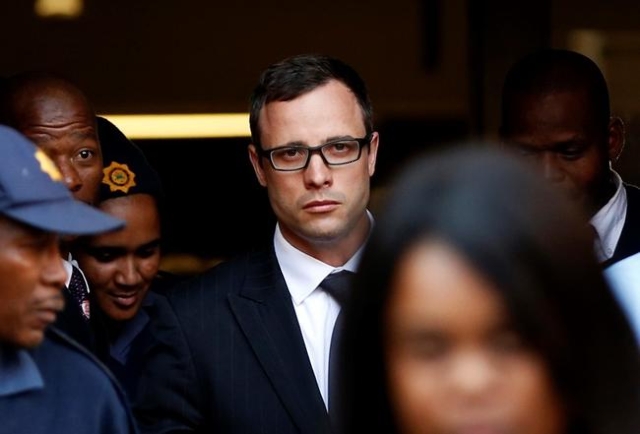 Paralympic track star Oscar Pistorius (C) leaves after listening to the closing arguments in his murder trial at the high court in Pretoria August 7, 2014. REUTERS/Siphiwe Sibeko/Files