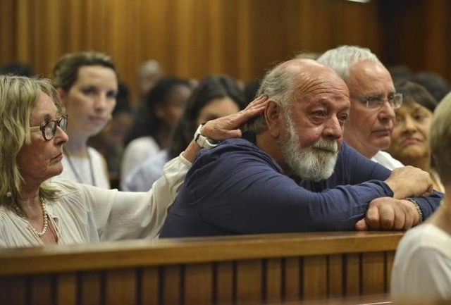 Barry Steenkamp, father of Reeva Steenkamp, is consoled by his wife June Steenkamp during the sentencing hearing of Olympic and Paralympic track star Oscar Pistorius at the North Gauteng High Cour ...