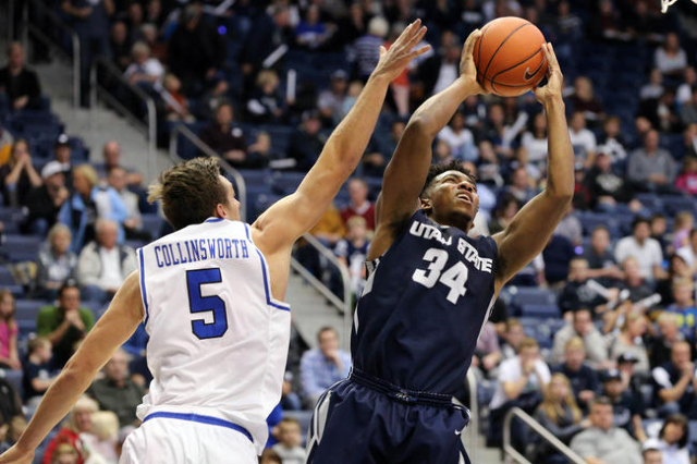 Dec 9, 2015; Provo, UT, USA; Utah State Aggies guard Chris Smith (34) gets past Brigham Young Cougars guard Kyle Collinsworth (5) and shoots the ball during the first half at Marriott Center. (Chr ...