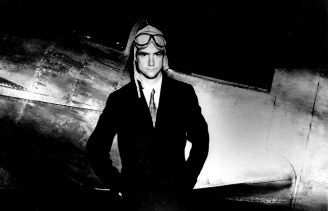 Businessman and aviator Howard Hughes poses beside his Hughes H-1 racing airplane. Hughes took part in the design of the aircraft, which he fles to set the world land speed record of 352 mph in 19 ...