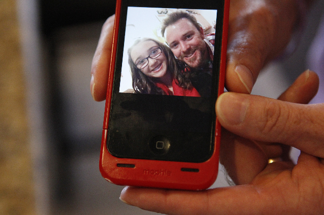 Jason Lamberth shows a picture with his daughter, Hailee, on his phone during an interview at his home in Henderson, Oct. 21, 2014. (Erik Verduzco/Las Vegas Review-Journal file)